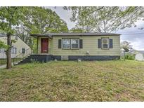 Quaint single-story home with a red door and a small, inviting front porch at 3540 Victoria St, Atlanta, GA 30337