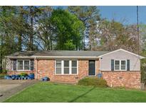Charming brick home with a well-manicured lawn and inviting curb appeal in a mature neighborhood setting at 2434 Skyland Ne Trl, Brookhaven, GA 30319