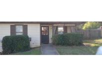 Charming home with front yard, sidewalk to door, and privacy hedge at 8219 Canyon Forge Dr, Riverdale, GA 30274