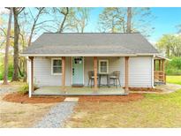 Charming single story home with a covered front porch, updated gray siding, and a light blue front door at 119 Old Vandiver Dr, Canton, GA 30114
