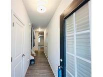 Bright hallway with wood-look flooring and neutral walls leading to various rooms within the home at 3132 Meadowstone Sw Ln, Atlanta, GA 30331