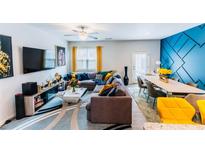 Bright living room featuring an L-shaped sofa, modern decor, and an accent wall at 3132 Meadowstone Sw Ln, Atlanta, GA 30331