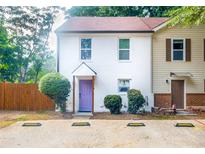 Charming townhouse with painted brick, purple door, and landscaped front yard at 5005 Pat Mell Se Pl, Smyrna, GA 30080