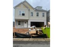 Two-story home with an unfinished garage and a yard in need of landscaping at 315 Lakeside Court, Canton, GA 30114