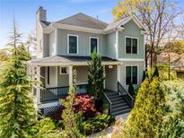 Charming two-story home featuring a welcoming front porch and beautifully landscaped front yard at 1324 Cambridge Ave. Sw, Atlanta, GA 30344