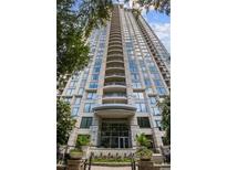 Tall condo building featuring balconies with multiple windows and decorative trees at the entrance at 3445 Stratford Ne Rd # 608, Atlanta, GA 30326