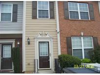 Charming townhome entrance with a decorative doorframe, brown shutters, and a well-maintained exterior at 2787 Deerwood Sw Ln, Atlanta, GA 30331