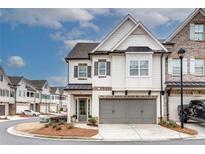 Charming two-story home featuring a gray two-car garage and inviting entrance at 525 Springer Nw Bnd, Marietta, GA 30060