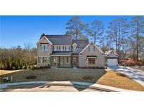 Stunning two-story brick home featuring an attached two car garage and manicured front lawn at 3812 Havenrock Dr, Marietta, GA 30066