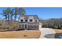 Beautiful new construction home featuring a brick and siding facade, manicured lawn, and paved driveway at 3816 Havenrock Drive, Marietta, GA 30066