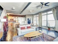 Spacious open-concept living room with exposed brick, modern furnishings, and lots of natural light at 350 Peters Sw St # 19, Atlanta, GA 30313