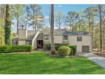 Charming home with mature trees and a well-manicured lawn, creating a welcoming curb appeal at 1870 Abercorn Way, Snellville, GA 30078