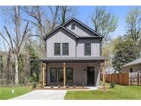 Charming two-story home featuring a gray exterior and a welcoming covered front porch at 1249 Ladd Sw St, Atlanta, GA 30310