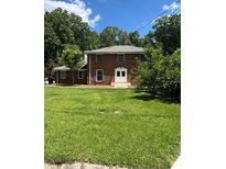 Charming brick two-story home featuring a lush green lawn and well-maintained landscaping at 1272 Seven Springs Cir, Marietta, GA 30068