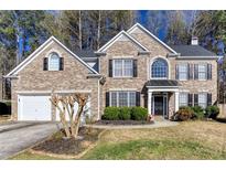 Charming brick two-story home with well-manicured lawn and attached two car garage at 2516 Woolwich Nw Ct, Acworth, GA 30101