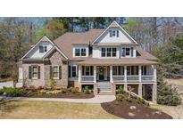 Charming two-story home features a welcoming front porch, landscaped yard, and a blend of stone and siding accents at 3227 Aviary Nw Ct, Acworth, GA 30101