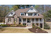 Beautiful two-story home featuring a welcoming front porch and manicured landscaping at 3227 Aviary Nw Ct, Acworth, GA 30101