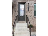 Inviting front door with brick facade, black handrails, and a stylish door number plaque at 308 Overture Ct, Smyrna, GA 30080