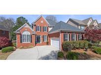 Charming two-story brick home with manicured lawn, black shutters, and attached garage at 3285 Millwood Se Trl, Smyrna, GA 30080
