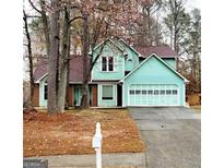 Charming two-story home with a well-maintained lawn and attached garage at 1034 Bettina Ct, Mableton, GA 30126