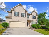 Charming two-story brick home with a two-car garage and well-manicured landscaping at 3048 Level Grove Ln, Dacula, GA 30019