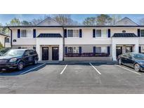 Exterior view of townhomes with parking spaces at 6940 Roswell Rd # 5B, Atlanta, GA 30328
