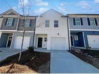 Charming townhomes with modern exteriors and individual driveways provide inviting curb appeal at 7109 Gladstone Cir, Lithonia, GA 30038