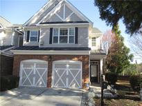 Charming townhome with a brick facade, two-car garage and professionally landscaped front yard at 11 Reese Way # 11, Avondale Estates, GA 30002