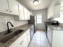 Updated kitchen featuring granite countertops, stainless steel appliances, and white cabinets at 3156 Nectarine Cir, Decatur, GA 30034