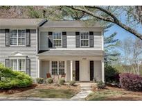 Charming two-story home with a well-manicured front yard and welcoming covered porch at 2306 Queen Anne Ct, Atlanta, GA 30350