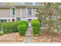 Charming townhouse exterior with neatly trimmed shrubs and a welcoming front entrance at 664 Powers Ferry North Se, Marietta, GA 30067