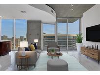 Bright living room with city views through large windows and sleek, contemporary design at 855 Peachtree Ne St # 2812, Atlanta, GA 30308