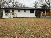Charming white brick ranch-style home with a well-manicured front yard and carport at 2662 Sweetwater Street, Austell, GA 30106