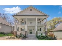 Charming two-story home featuring a double porch, beautiful landscaping, and a classic architectural design at 3055 Alston Dr, Decatur, GA 30032