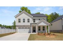 Charming two-story home with white brick accents and a two-car garage in a desirable neighborhood at 13562 Whitman Ln, Covington, GA 30014
