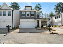 Charming two-story home with a modern exterior, featuring a gray facade and a spacious two-car garage at 8The07 Stickley Oak Way, Woodstock, GA 30189