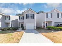 Charming townhome featuring a one-car garage and neutral siding at 222 Alton Cir, Villa Rica, GA 30180