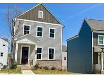 Charming two-story home with gray siding, complemented by a well-manicured lawn, brick foundation and ample natural light at 2705 Creek View Nw Ter, Atlanta, GA 30318