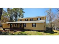Charming two-story home featuring a welcoming front porch and a well-maintained lawn at 1406 High Sierra Dr, Lawrenceville, GA 30043