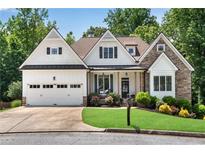 Charming home featuring a stone and white siding facade, complemented by a well-manicured lawn and inviting curb appeal at 244 Cedar Ridge Way, Dallas, GA 30157