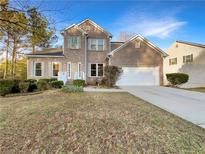 Charming two-story brick home with manicured front yard and attached two-car garage, perfect for a growing Gathering at 3110 Cambrian Ter, Austell, GA 30106