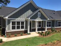 Charming single-story home with gray siding, white trim, and a well-manicured lawn and landscape at 1702 Bonica Xing # 1702, Cumming, GA 30040