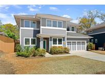 Charming two-story home with gray siding, white trim, and a manicured lawn, showcasing its curb appeal at 1903 River Birch Ln, Atlanta, GA 30316