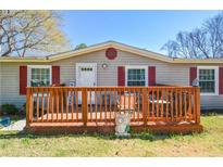 Charming home features a front porch, red shutters, and inviting curb appeal at 177 Carolyn Se Ct, Acworth, GA 30101