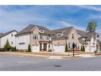 Charming, two-story home with brick and siding exterior and two-car garage at 6210 Bellmoore Park Ln, Duluth, GA 30097