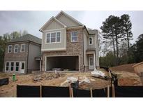 Charming two-story home with brick and beige siding and an attached two car garage in a new neighborhood at 1974 William Glen St, Dacula, GA 30019