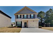 Charming two-story home with a brick and gray facade, black shutters, and an attached one-car garage at 5863 Little River Rd, Atlanta, GA 30349