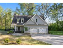 Charming two-story home with attached two-car garage and landscaped front yard at 2442 Lower Union Hill Rd, Canton, GA 30115