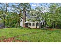 Charming cottage-style home with stone chimney and lush front yard at 2601 Semmes St, Atlanta, GA 30344
