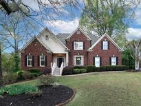 Charming brick home featuring manicured lawn and stylish front entrance at 1514 Haven Crest Dr, Powder Springs, GA 30127